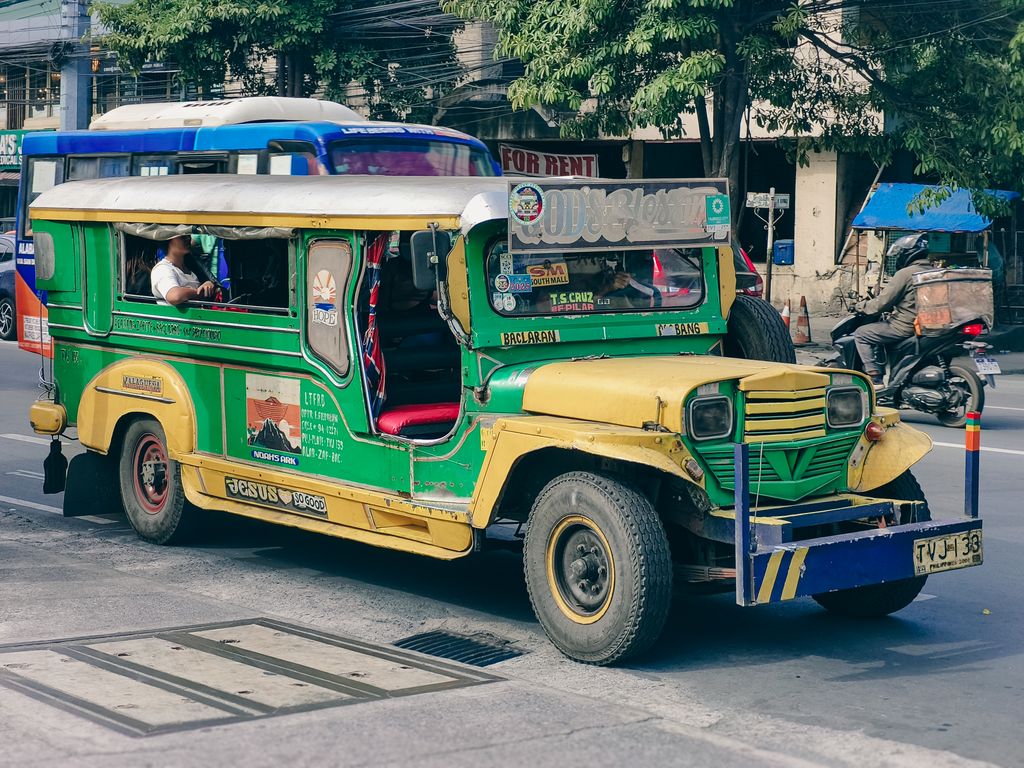 Iconic Philippine jeepney parked on a busy urban street, showcasing vibrant local transport culture.